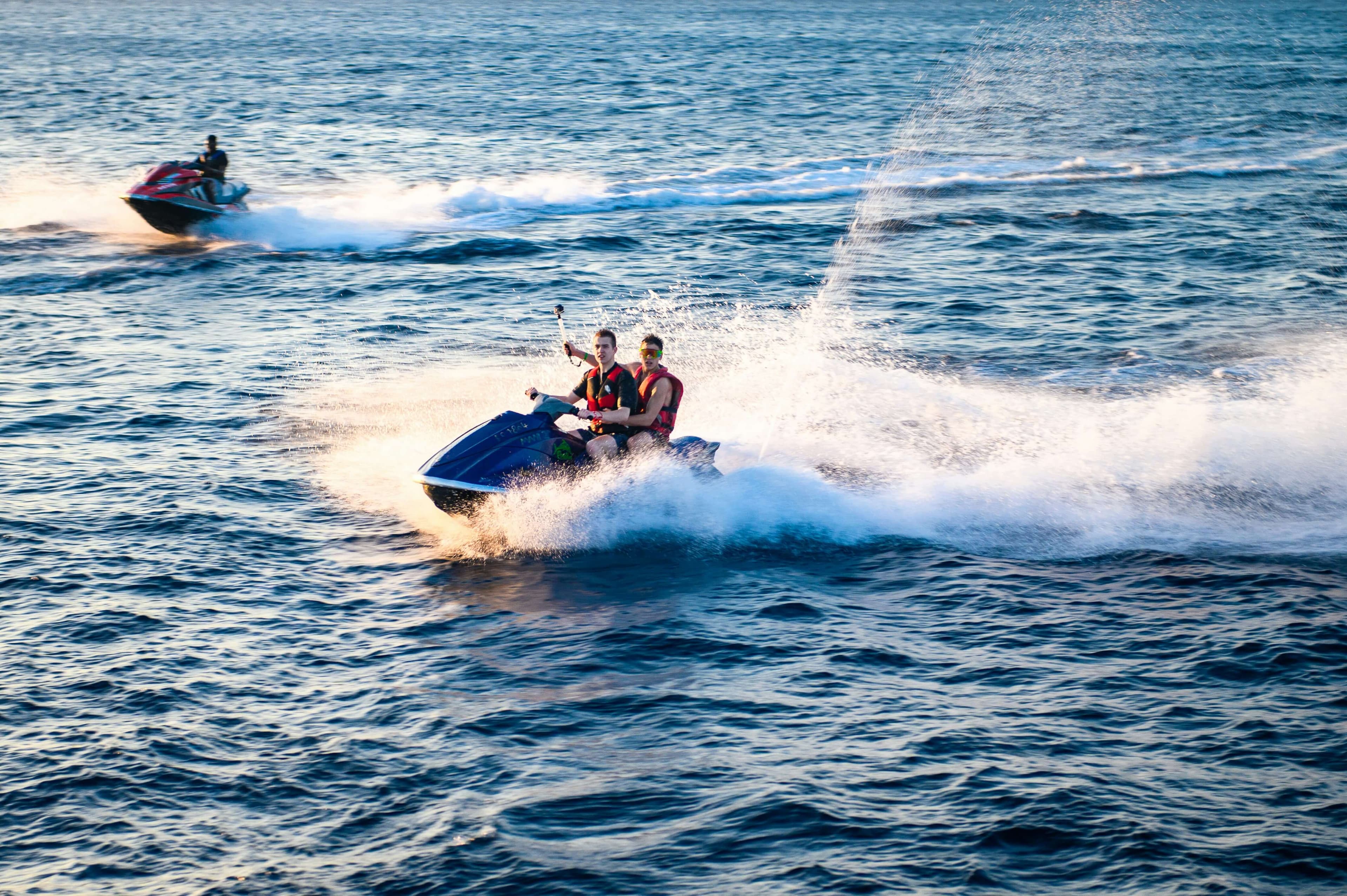 Guests riding a jetski off the resort's shoreline